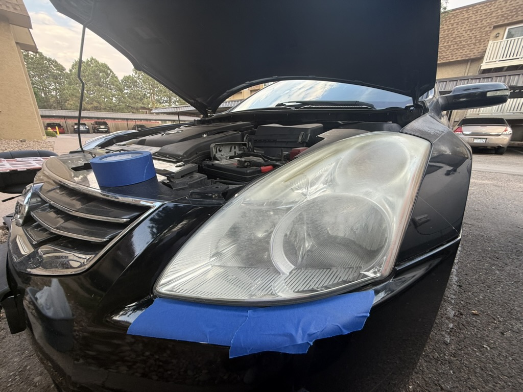 2011 Nissan Altima before headlight restoration — cloudy, yellowed headlights
