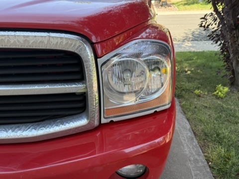 2003 Dodge Durango headlight after restoration showing a clear exterior lens