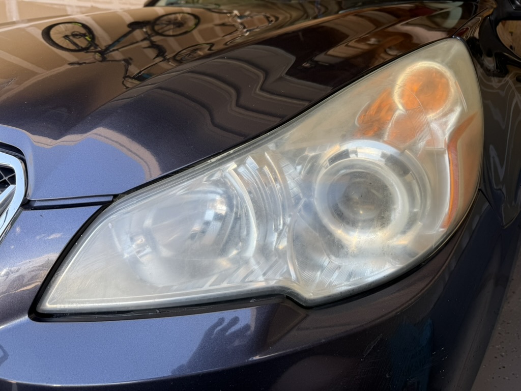 Subaru before headlight restoration — cloudy, yellowed headlights