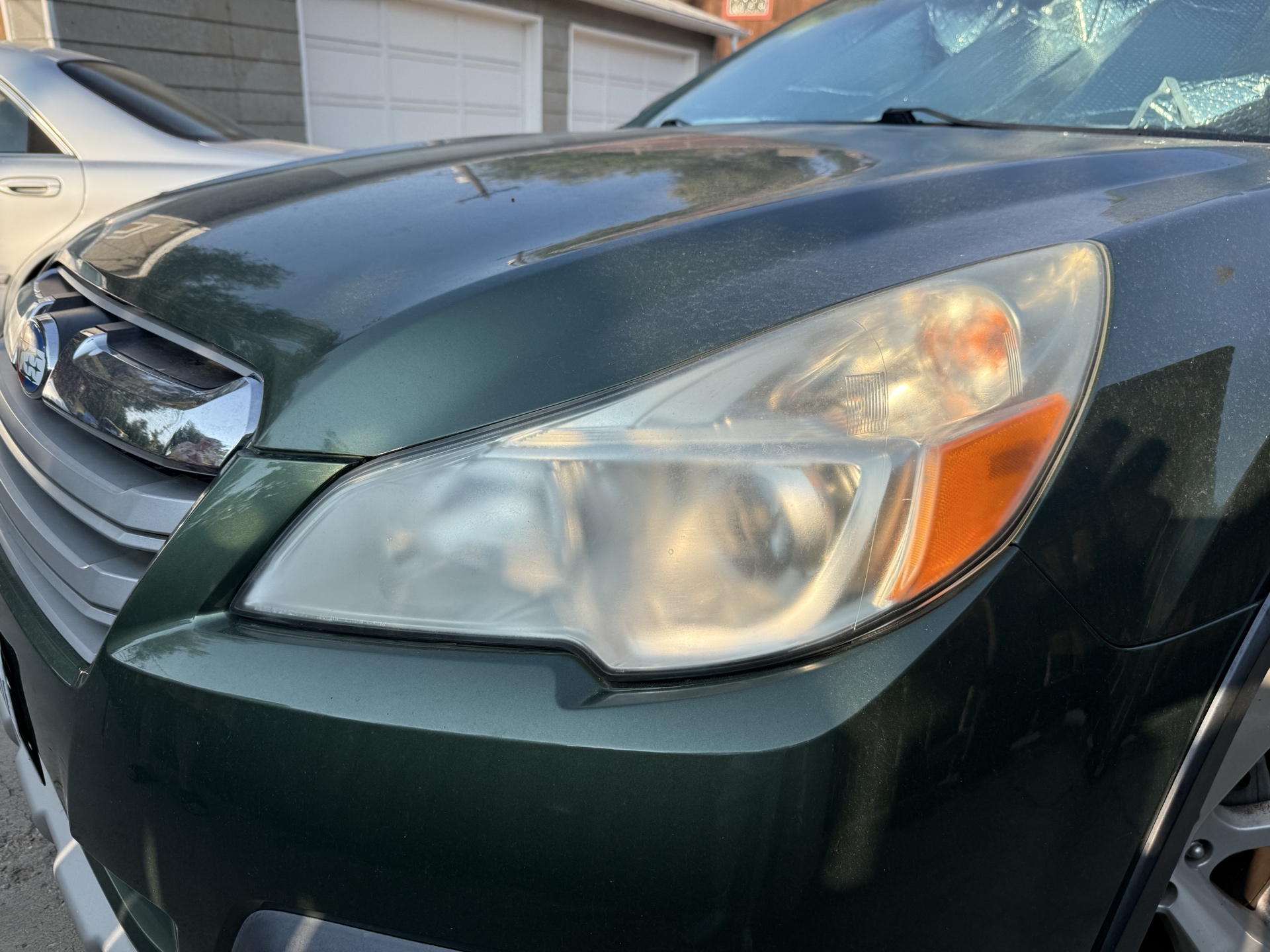 Subaru Outback before headlight restoration — cloudy, yellowed headlights