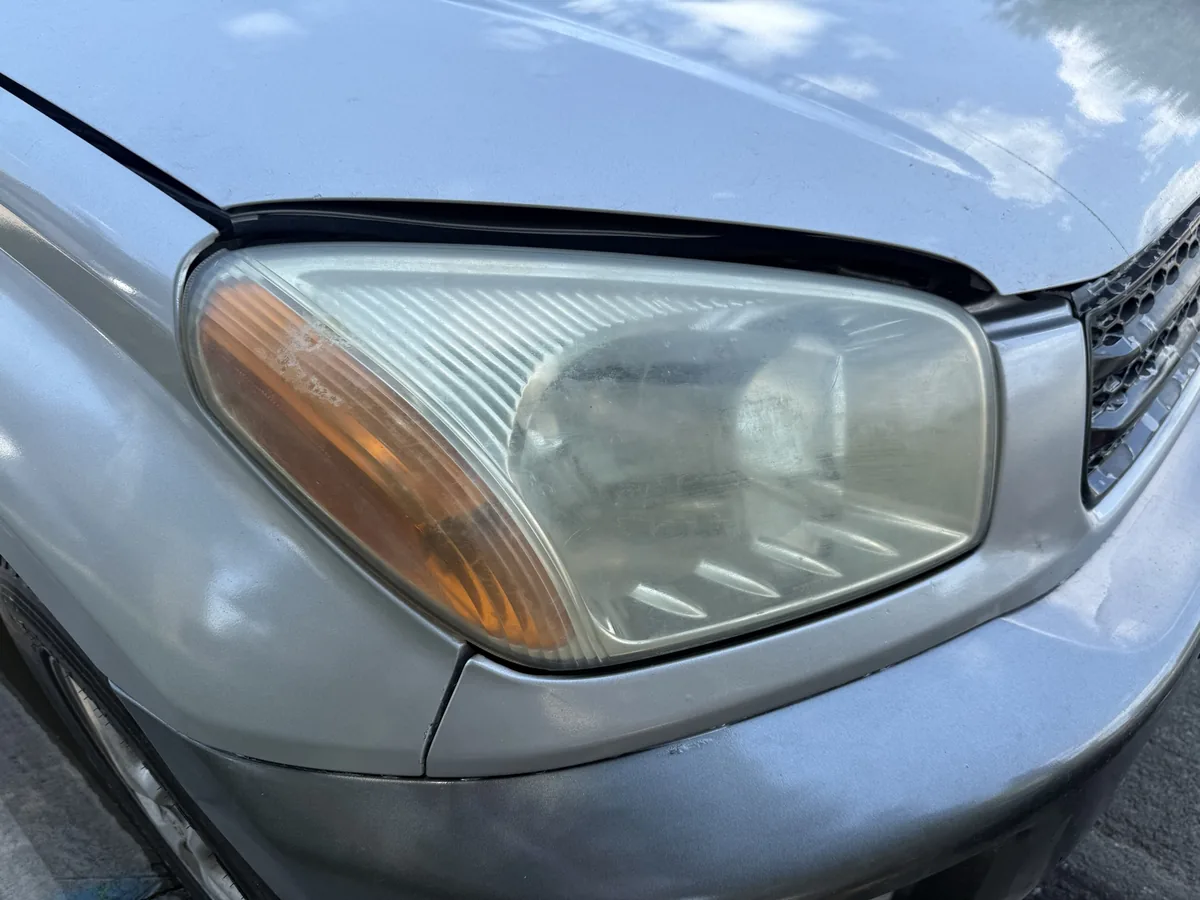 Toyota RAV4 cloudy yellowed headlights before restoration — Centennial, CO — Headlight Boost