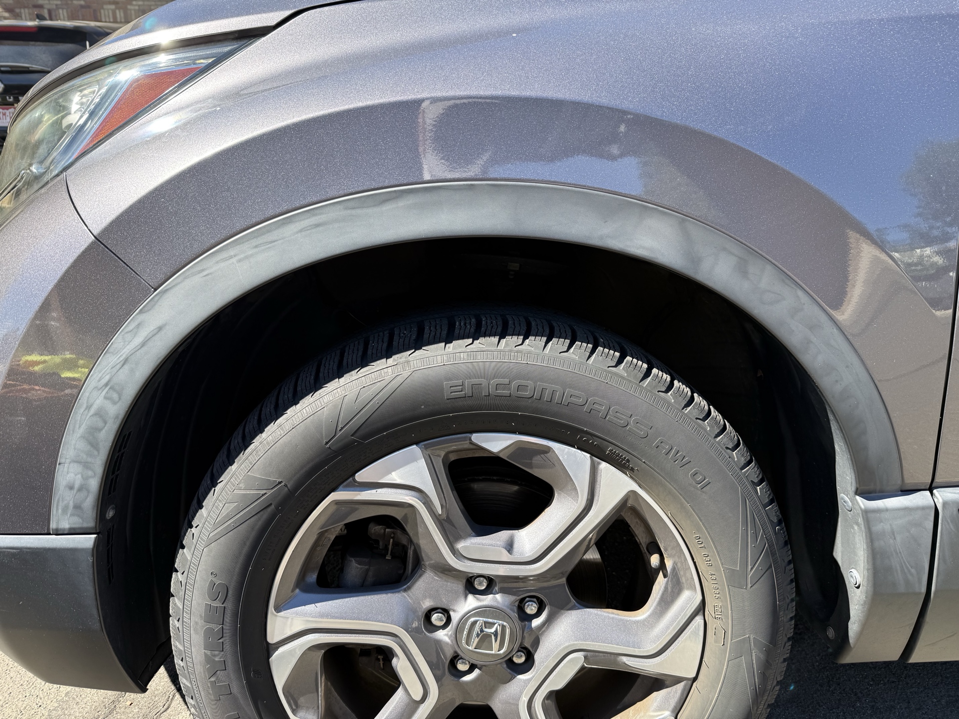 Faded wheel-arch trim before restoration